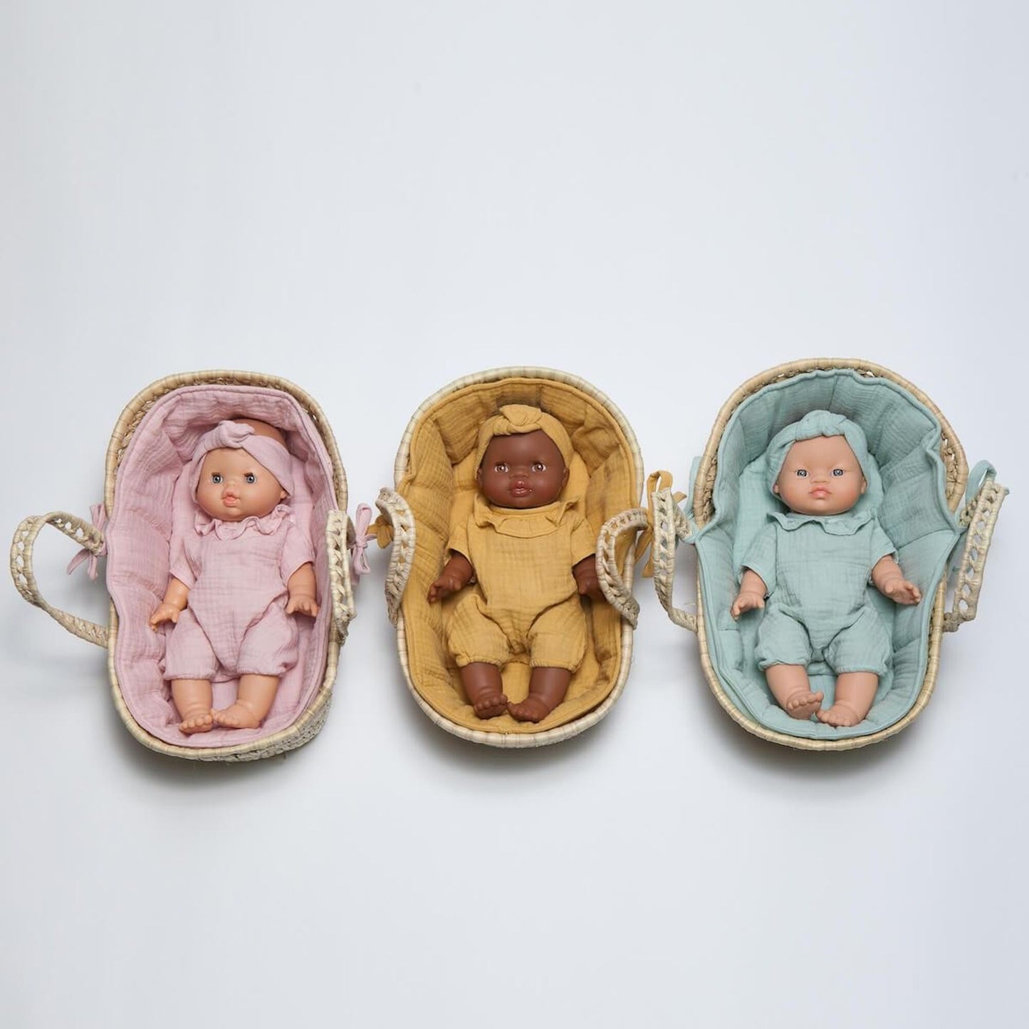 Three dolls in baskets