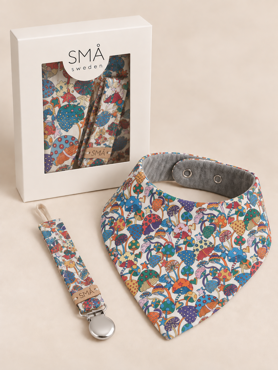 SMÅ Liberty Magic newborn gift set with colourful baby bib and matching pacifier clip in white gift box