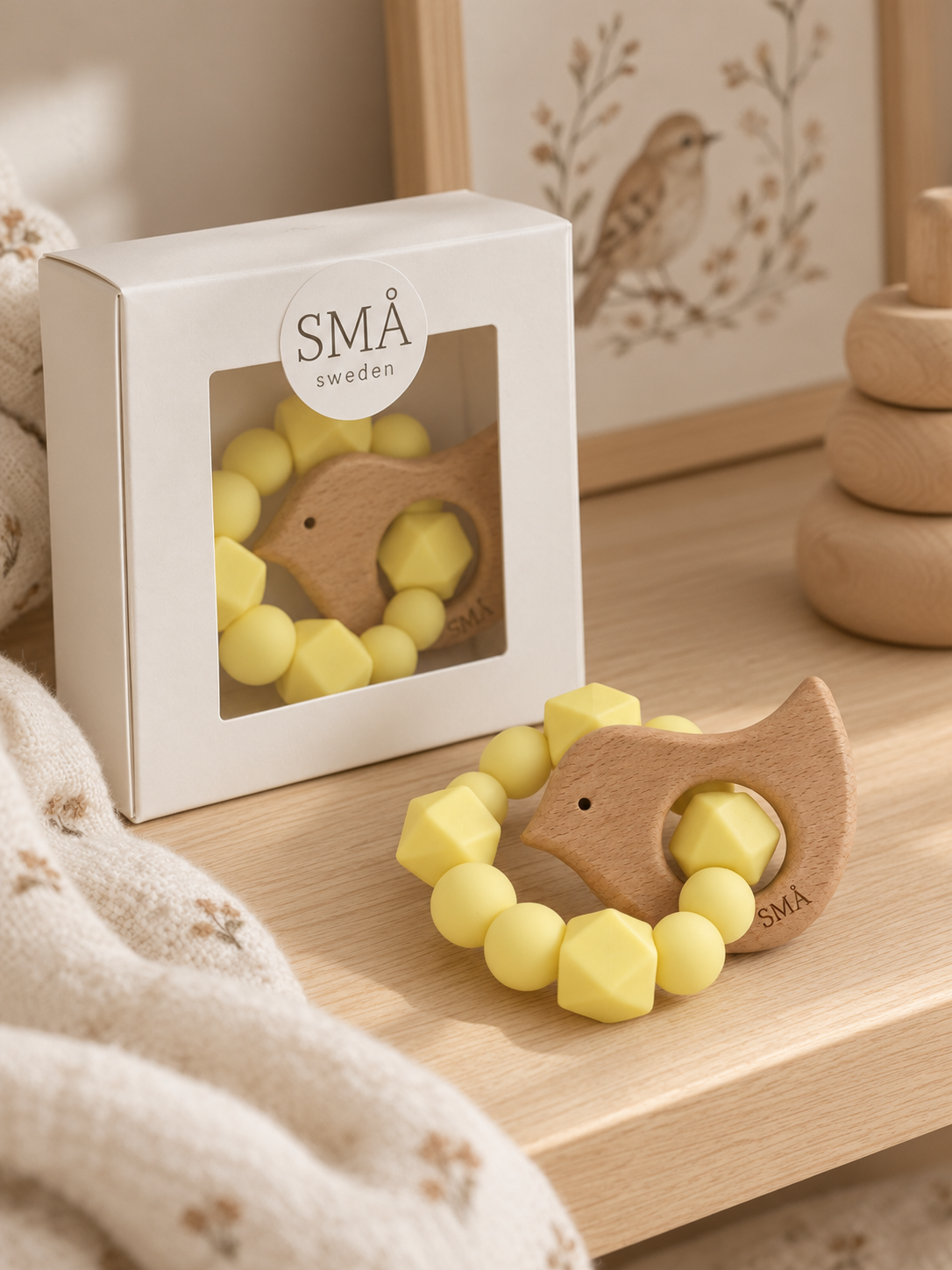 SMÅ Birdy Baby Teether in yellow silicone and beech wood presented in a gift box